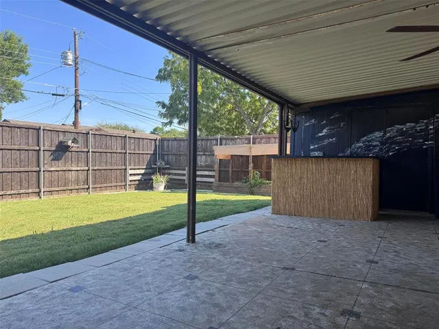 a view of a backyard with roof deck and sitting area