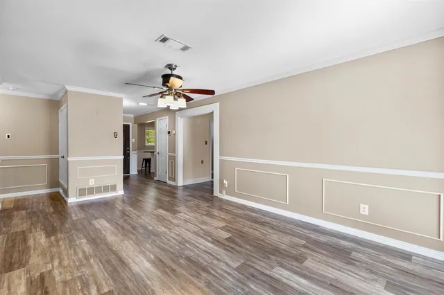 a view of a room with wooden floor