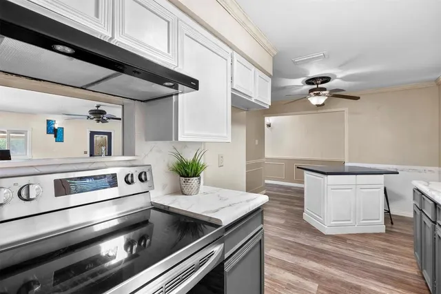 a kitchen with stove and cabinets