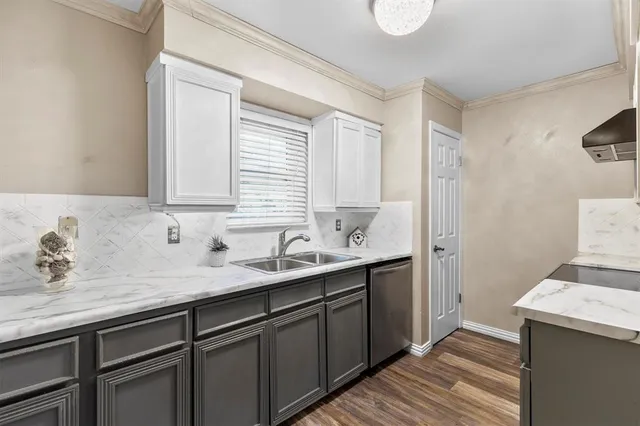 a kitchen with a sink and cabinets