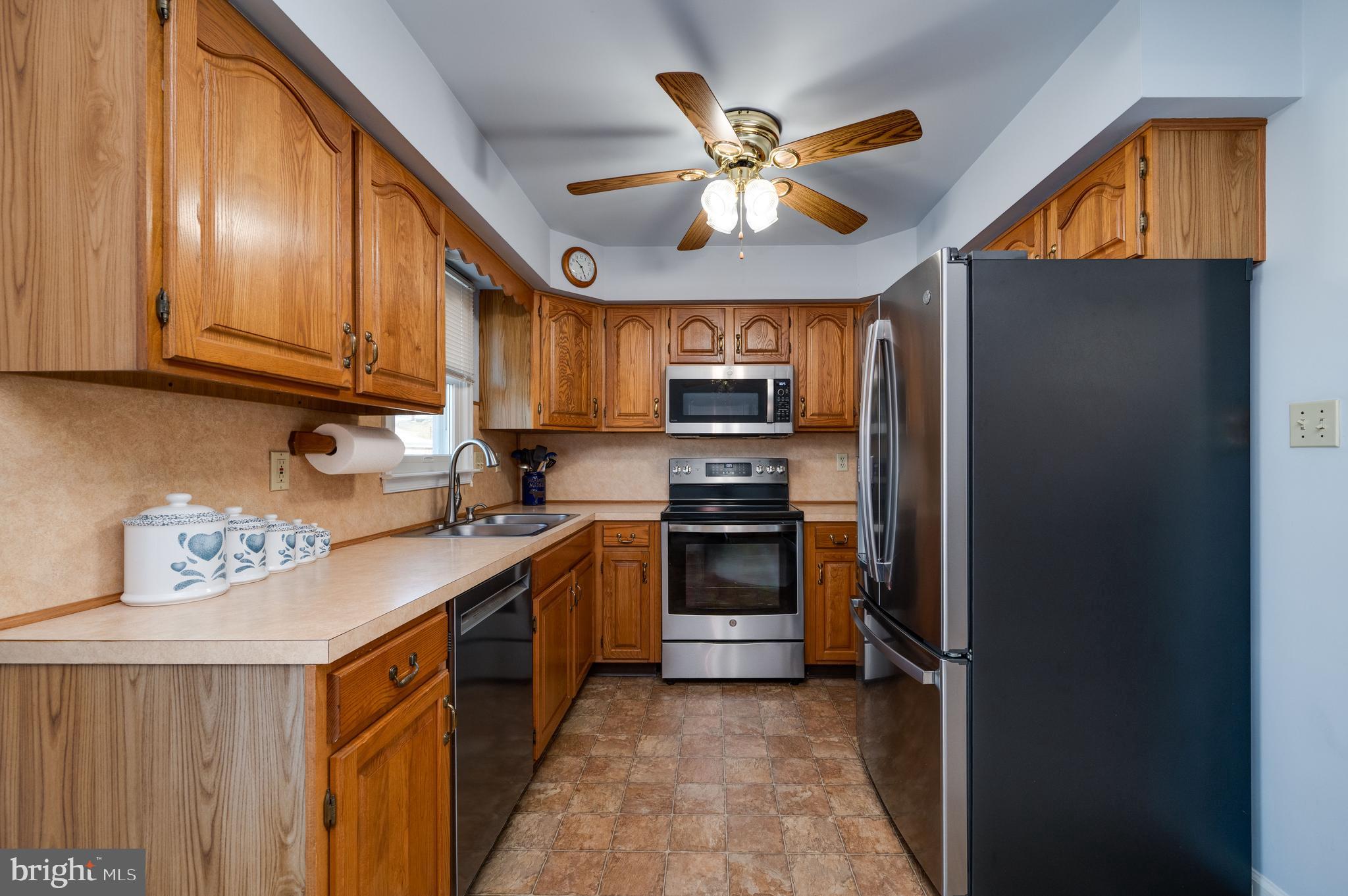 523 Mount Laurel Road Temple, PA 19560 - Photo 17 of 36 a kitchen with refrigerator cabinets and window