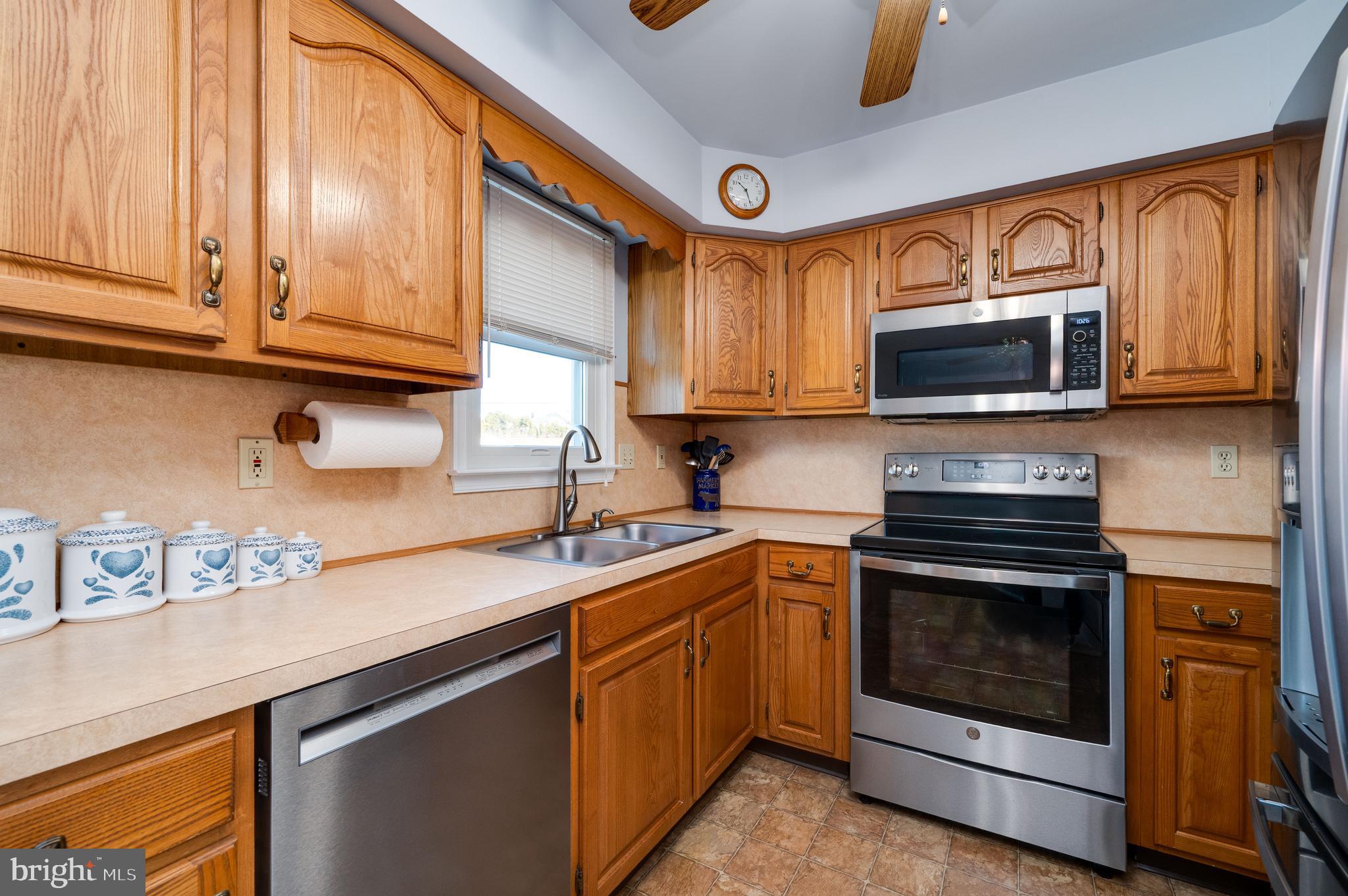 523 Mount Laurel Road Temple, PA 19560 - Photo 18 of 36 a kitchen with stainless steel appliances granite countertop a sink a stove a microwave and cabinets