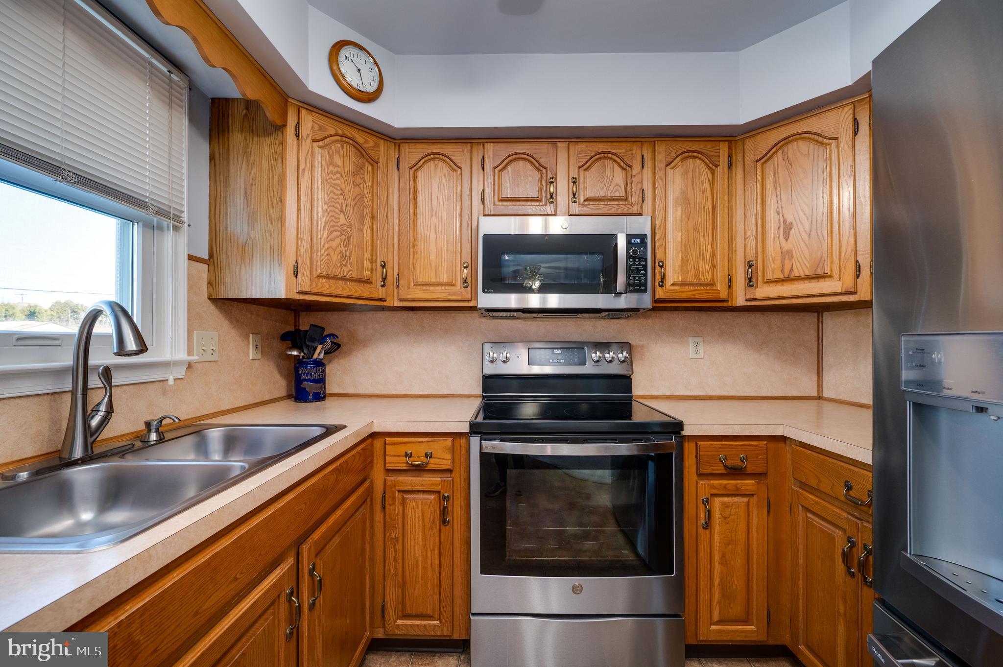 523 Mount Laurel Road Temple, PA 19560 - Photo 19 of 36 a kitchen with stainless steel appliances granite countertop a sink stove and microwave