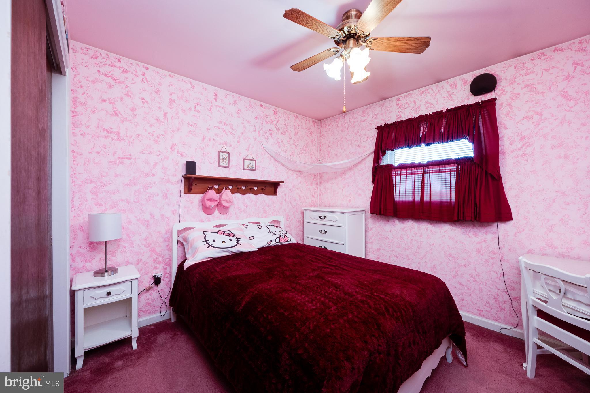 523 Mount Laurel Road Temple, PA 19560 - Photo 23 of 36 a bedroom with a bed and a chandelier