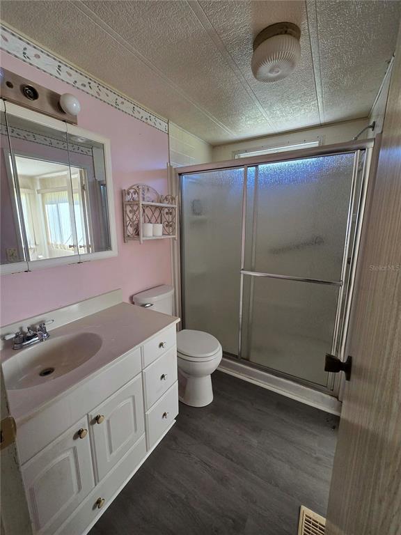 1991 Southeast 170th Avenue Road Silver Springs, FL 34488 - Photo 13 of 18 a bathroom with a granite countertop sink toilet a mirror and shower