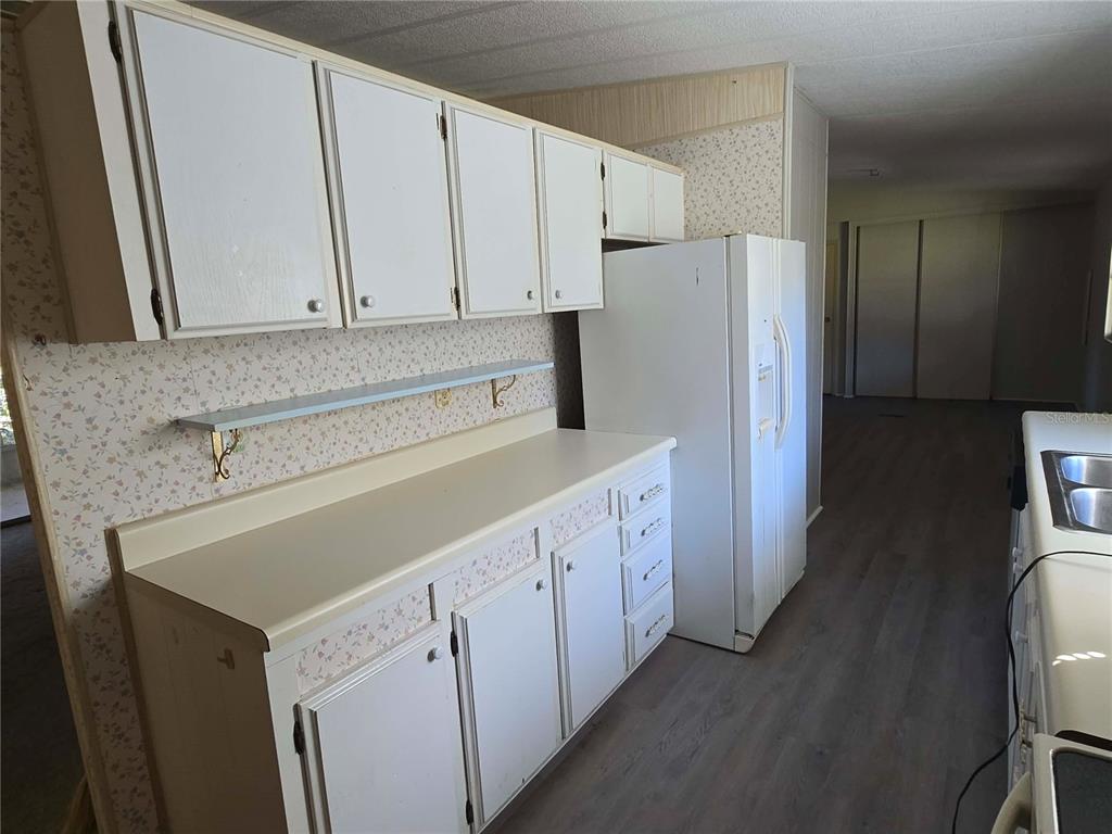 1991 Southeast 170th Avenue Road Silver Springs, FL 34488 - Photo 7 of 18 a kitchen with white cabinets and refrigerator