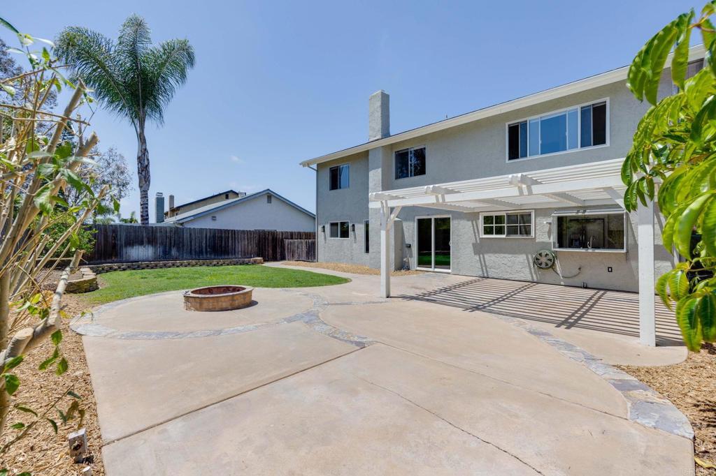 4595 Blackwell Road Oceanside, CA 92056 - Photo 41 of 47 a view of a house with a yard and a large tree