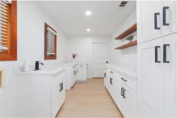 a bathroom with double vanity and mirrors