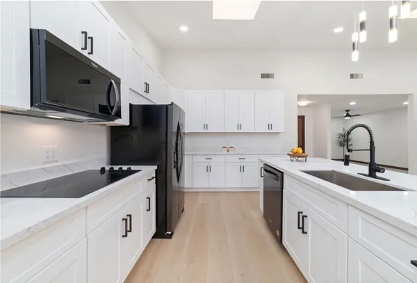 a kitchen with a sink stove and refrigerator