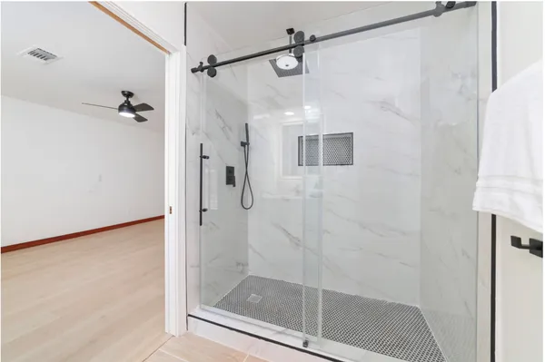 a bathroom with a glass shower door