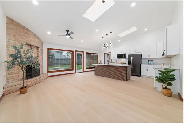 a view of kitchen with furniture and refrigerator