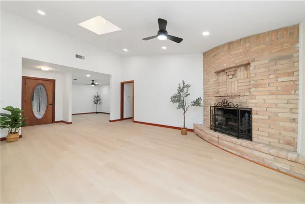 a view of an empty room with a fireplace