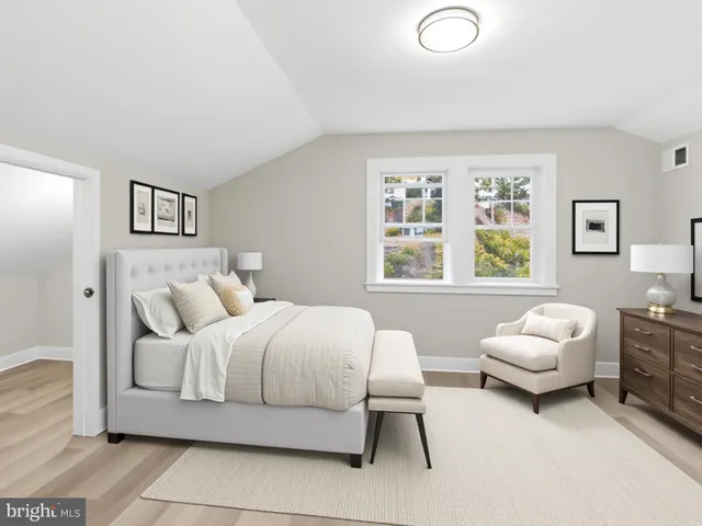 a bedroom with a bed and a couch