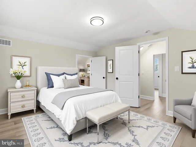 a spacious bedroom with a bed and a couch