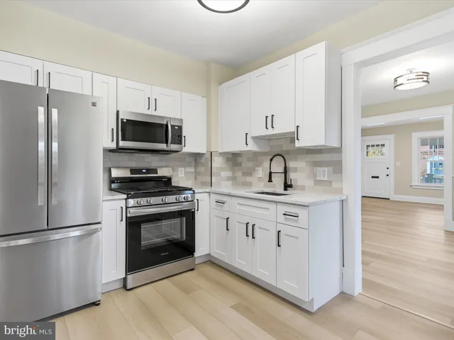 a kitchen with stainless steel appliances a refrigerator stove and microwave