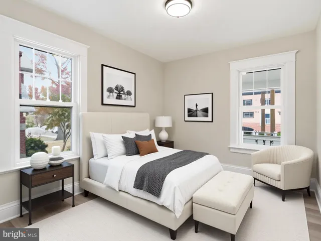 a bedroom with a bed and glass window