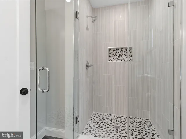 a bathroom with a shower and a shower