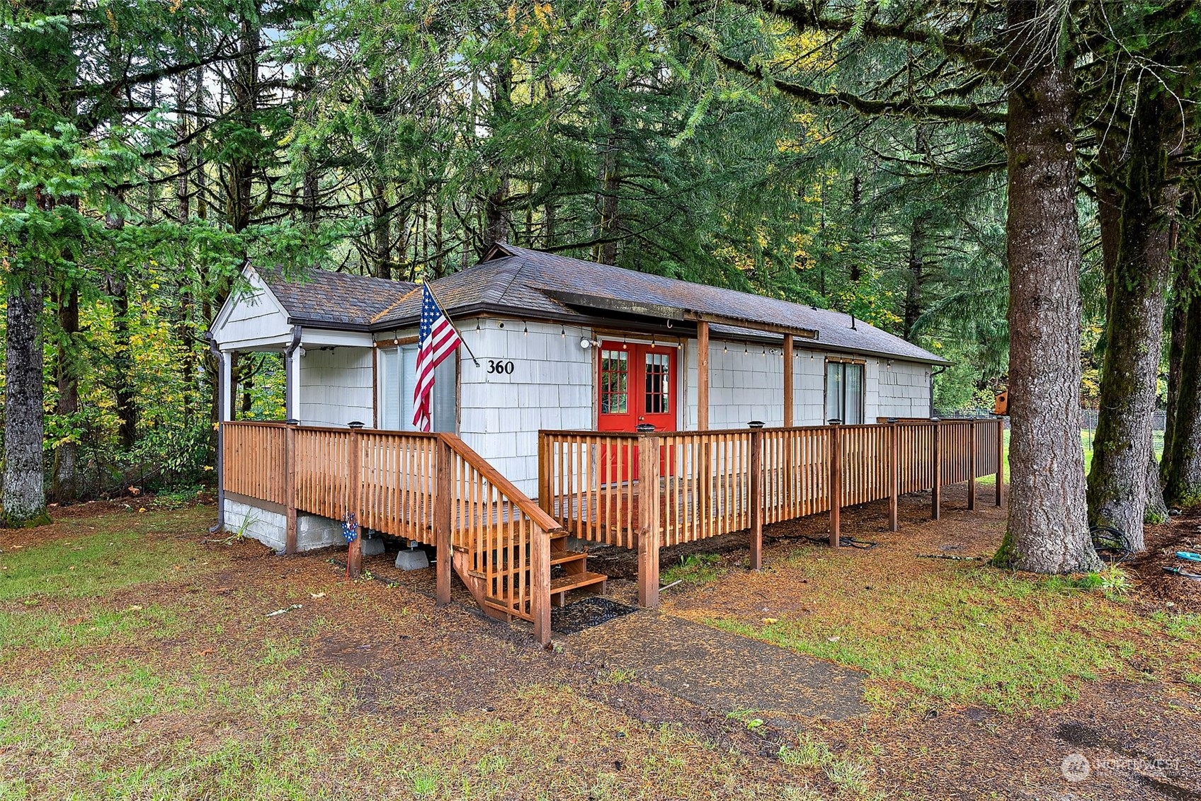 360 Highway 7 Morton, WA 98356 - Photo 1 of 23 a view of a house with a yard and deck area under a large tree