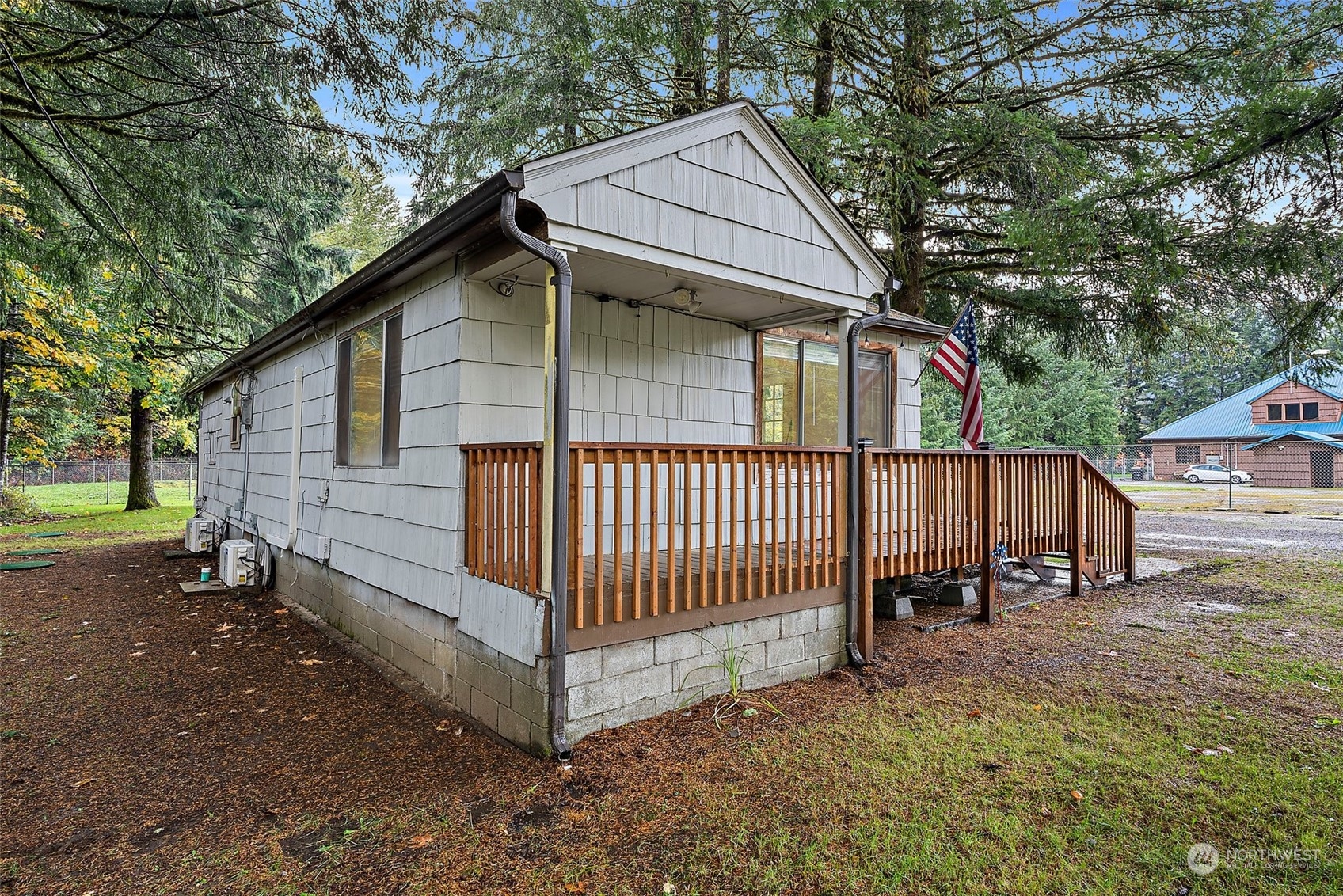 360 Highway 7 Morton, WA 98356 - Photo 2 of 23 a view of a small house with wooden fence and trees