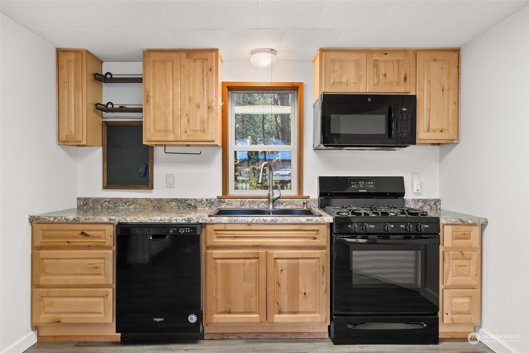 360 Highway 7 Morton, WA 98356 - Photo 8 of 23 a kitchen with stainless steel appliances granite countertop a stove and a microwave