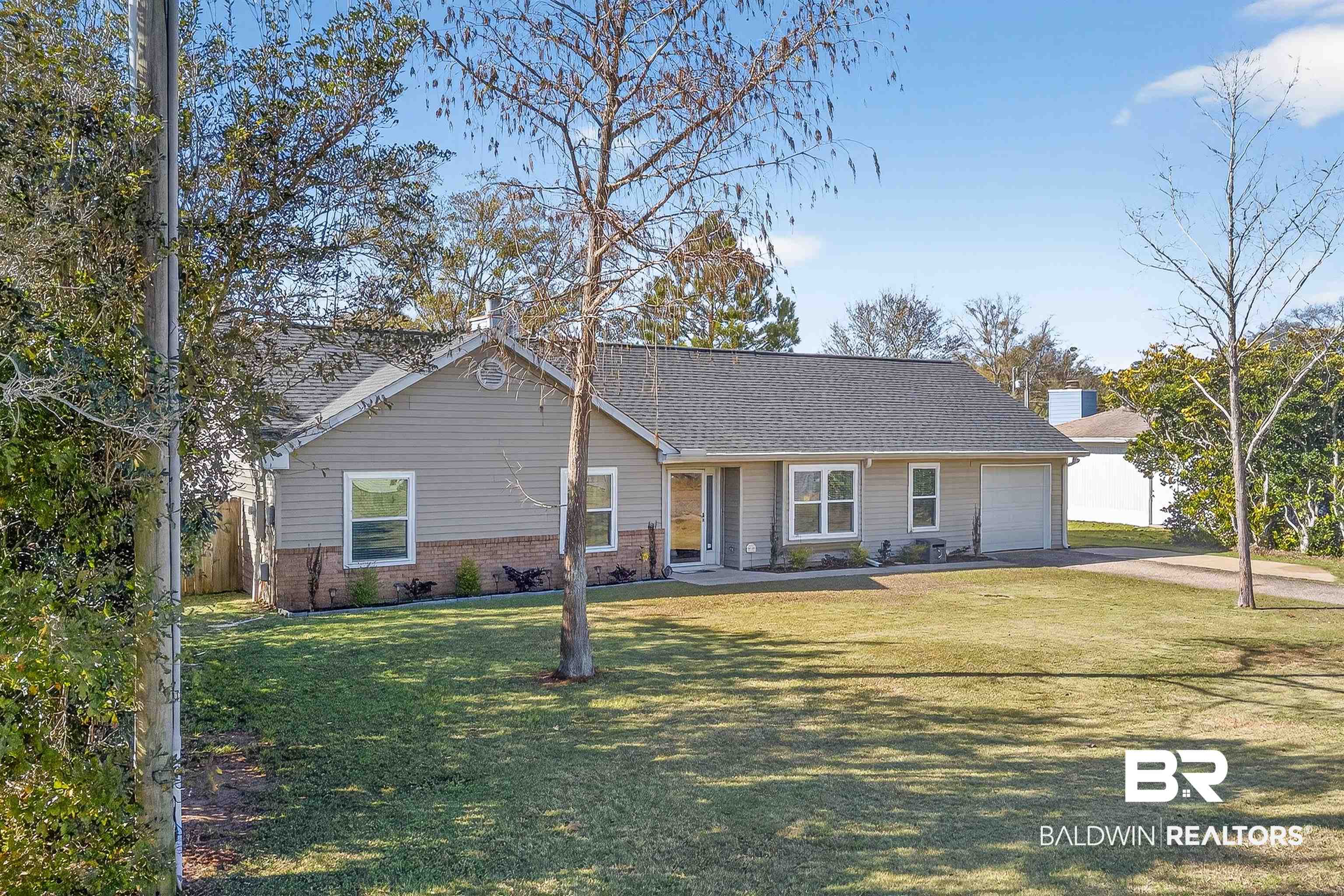 2 Magnolia Circle Foley, AL 36535 - Photo 40 of 45 Ranch-style home featuring brick siding, a front lawn, driveway, a garage, and a shingled roof