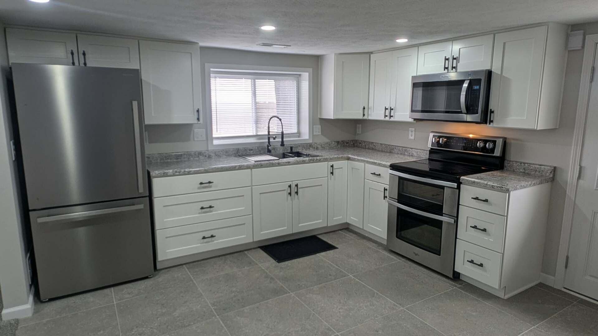 720 East Marion Street Clinton, IL 61727 - Photo 4 of 22 a kitchen with stainless steel appliances granite countertop a refrigerator stove a sink and a microwave