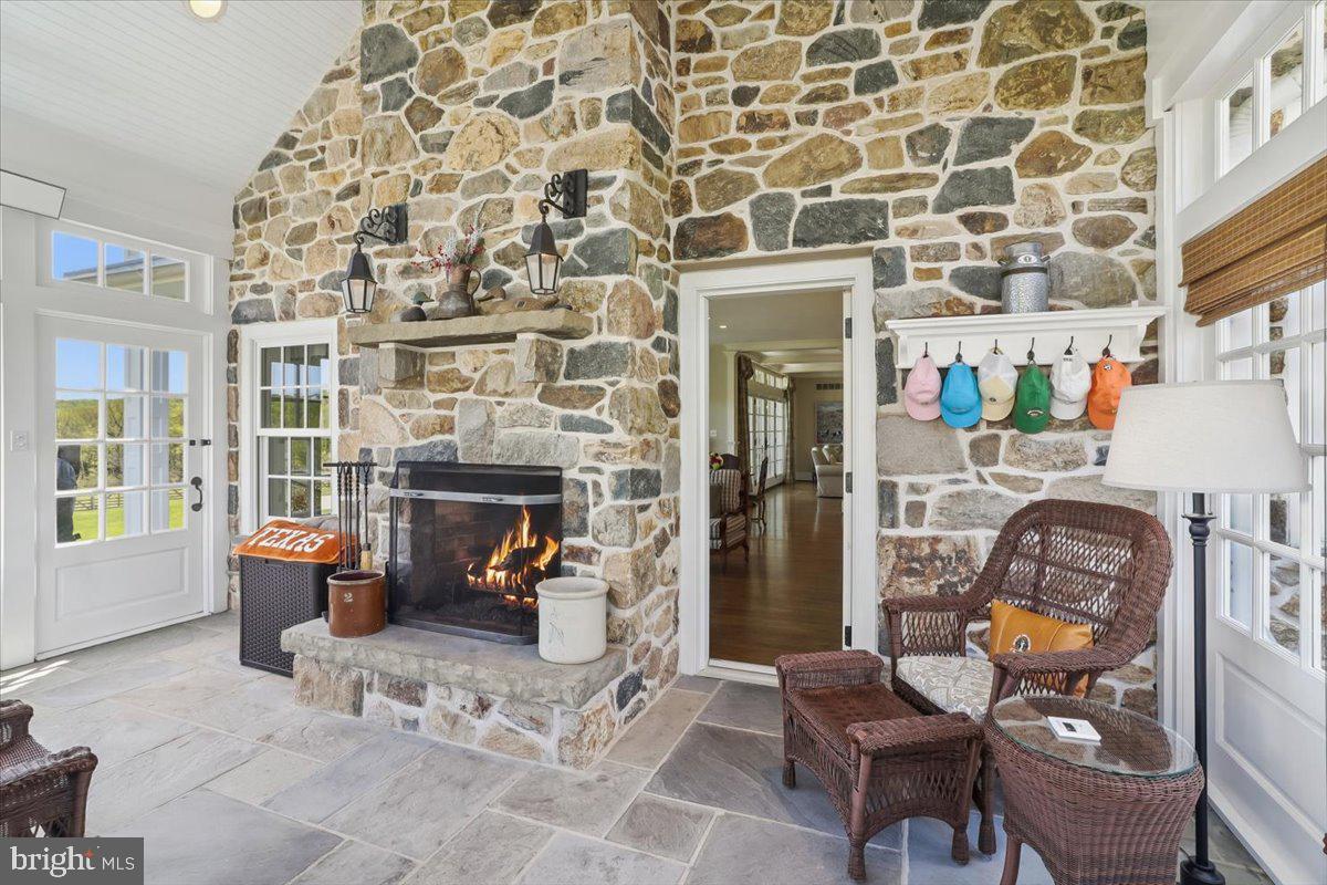 182 Trythall Road Elverson, PA 19520 - Photo 23 of 76 a living room with patio fireplace furniture and a fireplace