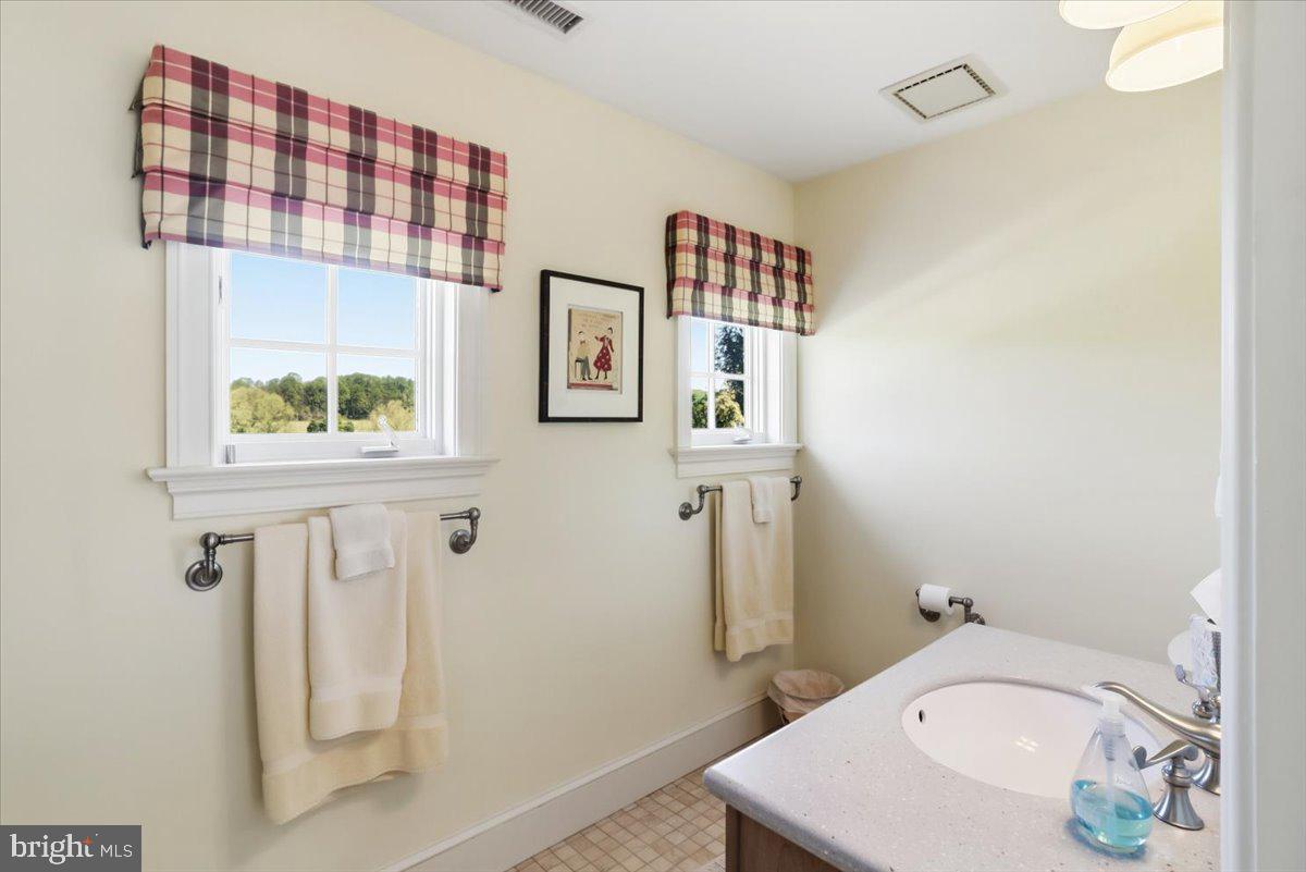 182 Trythall Road Elverson, PA 19520 - Photo 54 of 76 a bathroom with a sink and mirror