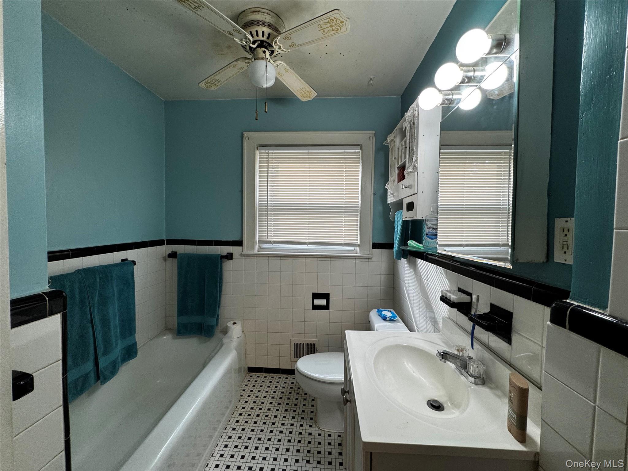 351 Nicolls Road Deer Park, NY 11729 - Photo 13 of 16 a bathroom with a sink a toilet and mirror