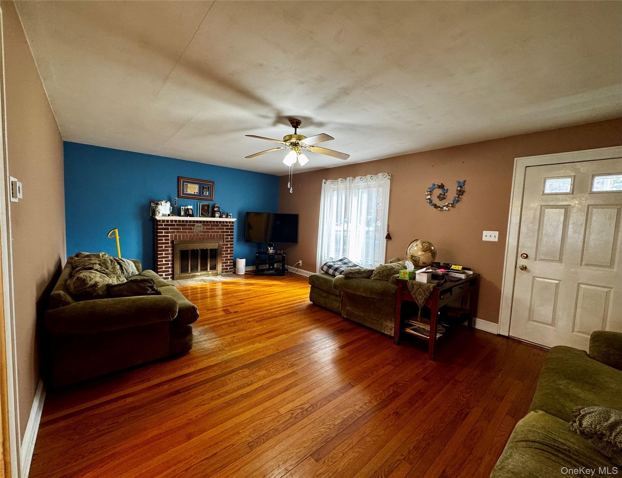 351 Nicolls Road Deer Park, NY 11729 - Photo 2 of 16 a living room with furniture and a fireplace