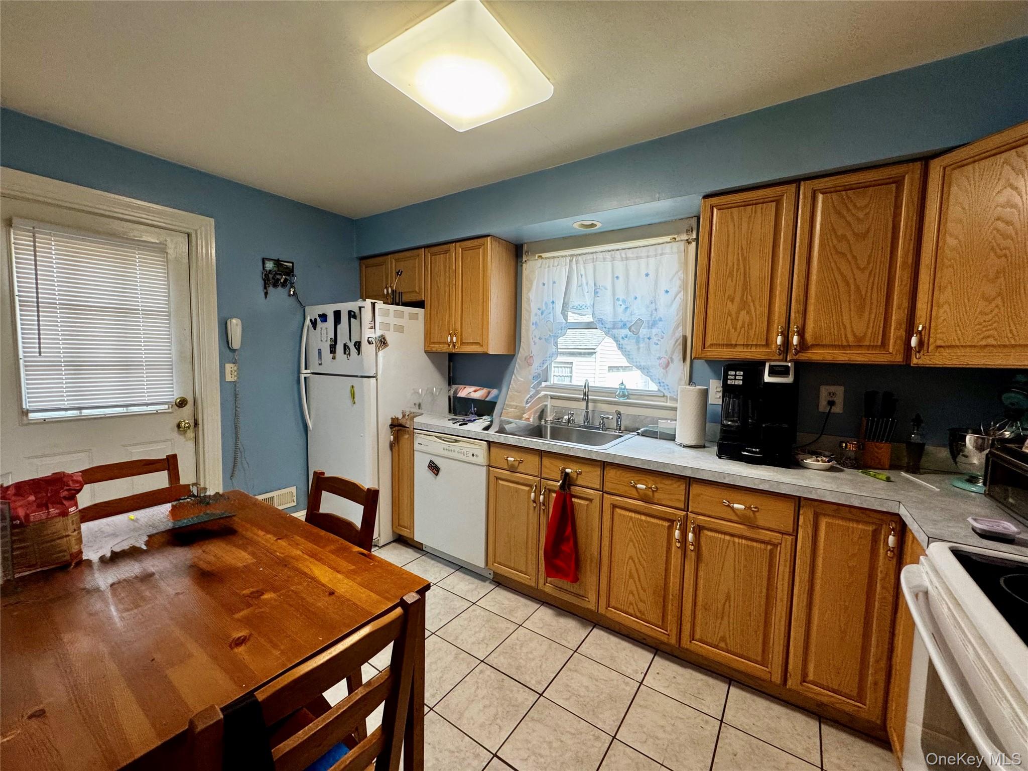 351 Nicolls Road Deer Park, NY 11729 - Photo 6 of 16 a kitchen with stainless steel appliances granite countertop a stove top oven a sink dishwasher and cabinets with wooden floor
