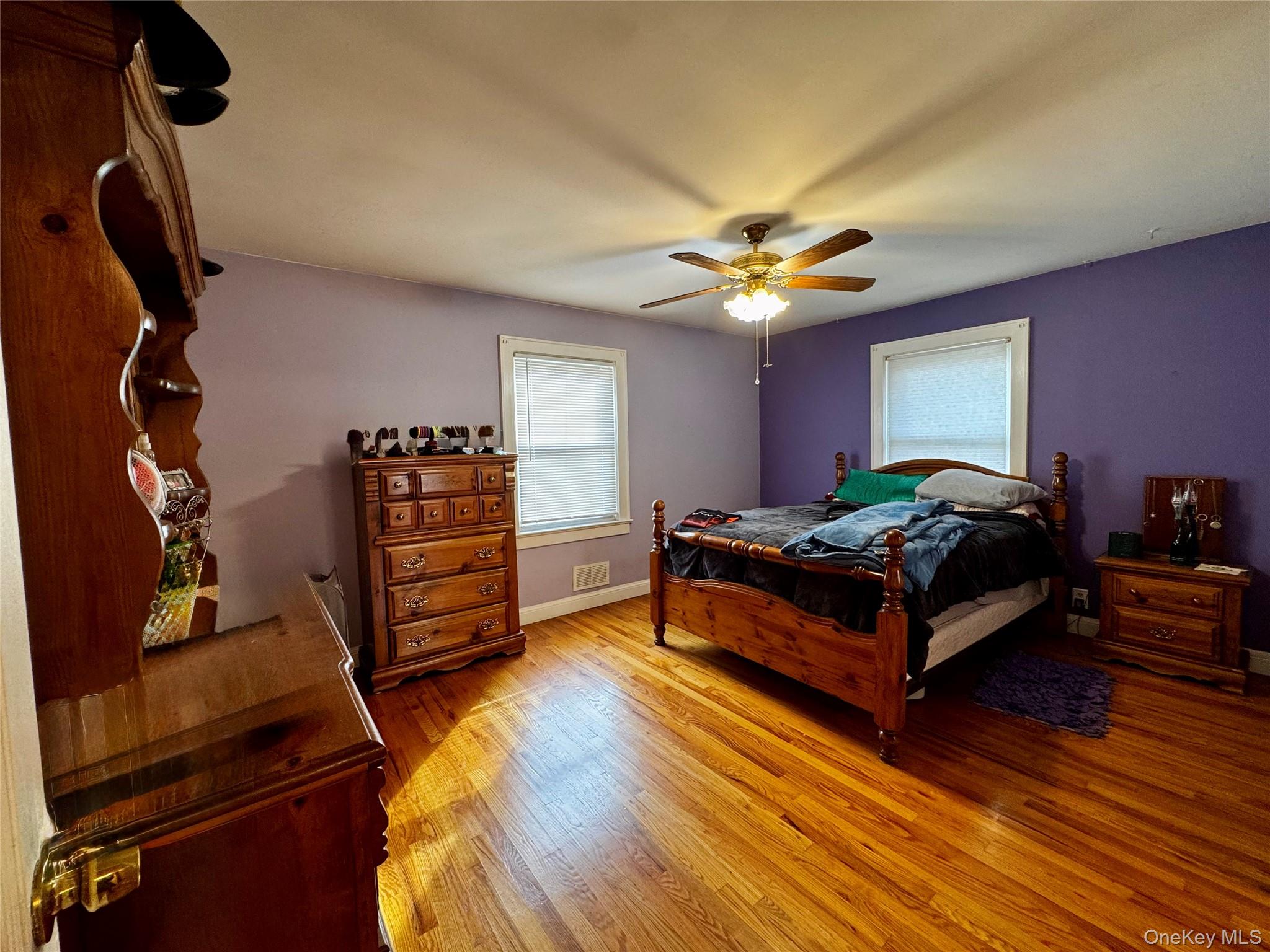 351 Nicolls Road Deer Park, NY 11729 - Photo 9 of 16 a spacious bedroom with a bed and a chandelier