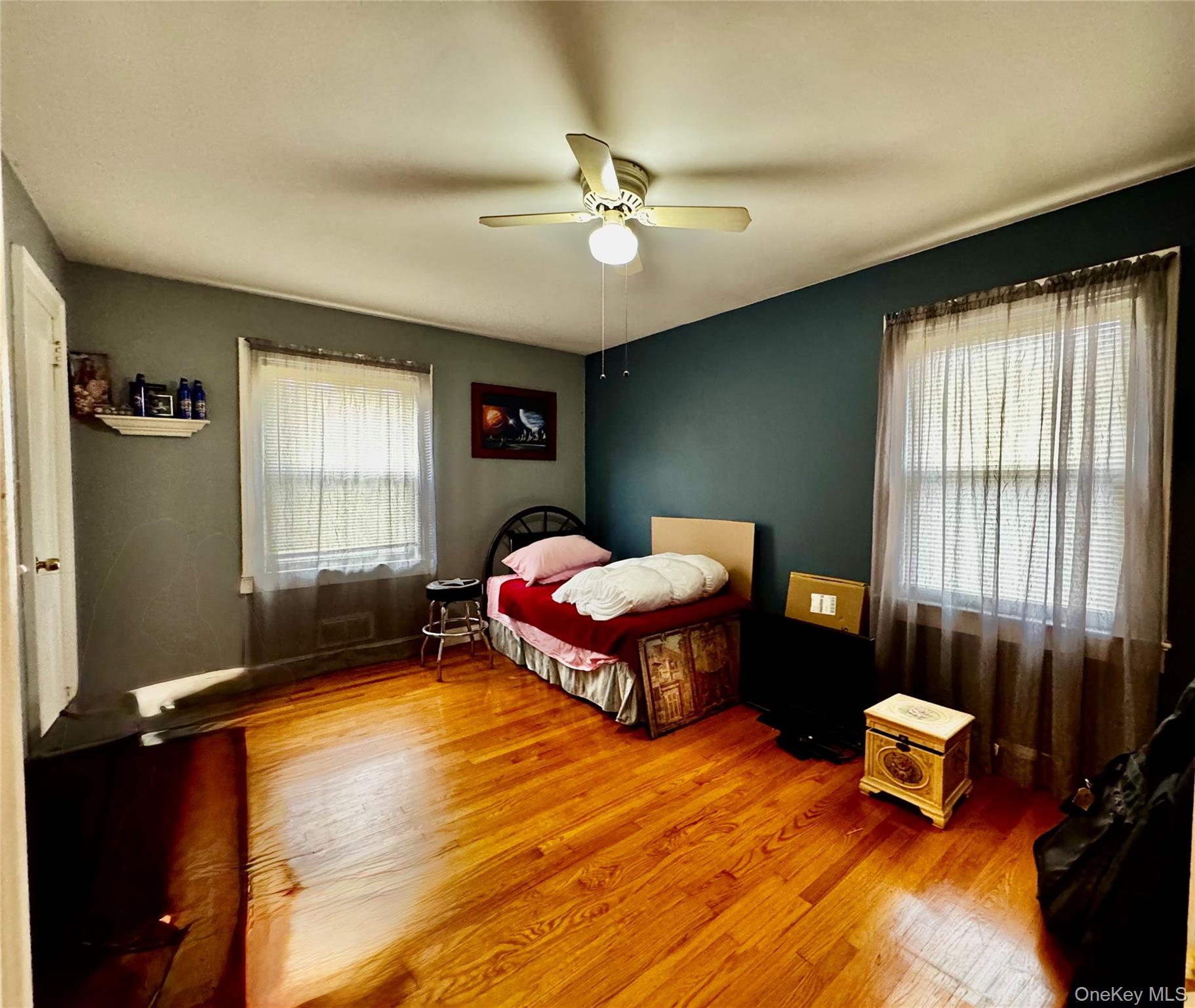 351 Nicolls Road Deer Park, NY 11729 - Photo 10 of 16 a bedroom with a bed and a chandelier