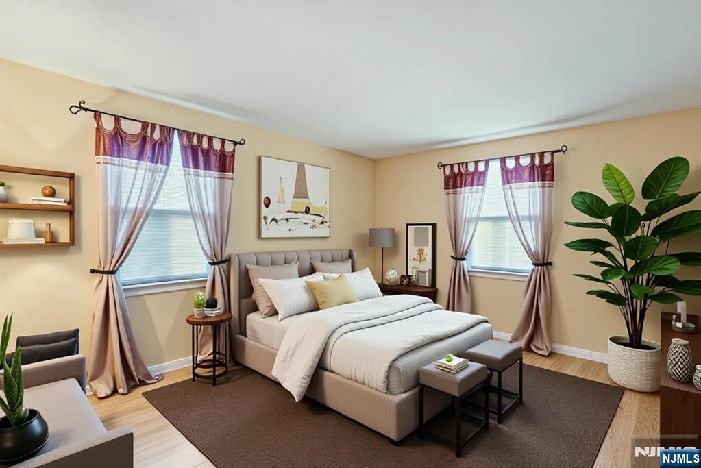 90 Arnot Place Paramus, NJ 07652 - Photo 14 of 32 a bedroom with a bed and a potted plant
