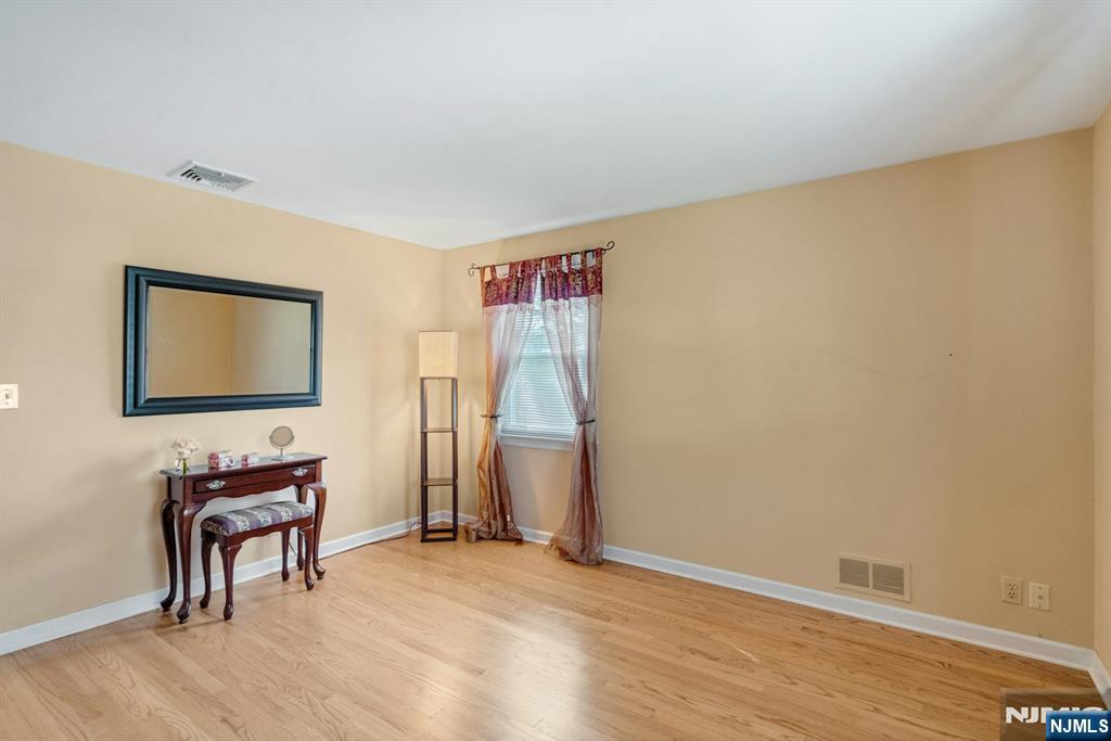 90 Arnot Place Paramus, NJ 07652 - Photo 15 of 32 a view of a livingroom with wooden floor and a workspace
