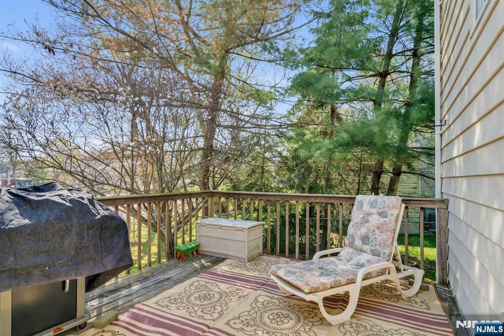90 Arnot Place Paramus, NJ 07652 - Photo 22 of 32 a balcony with wooden floor and outdoor seating