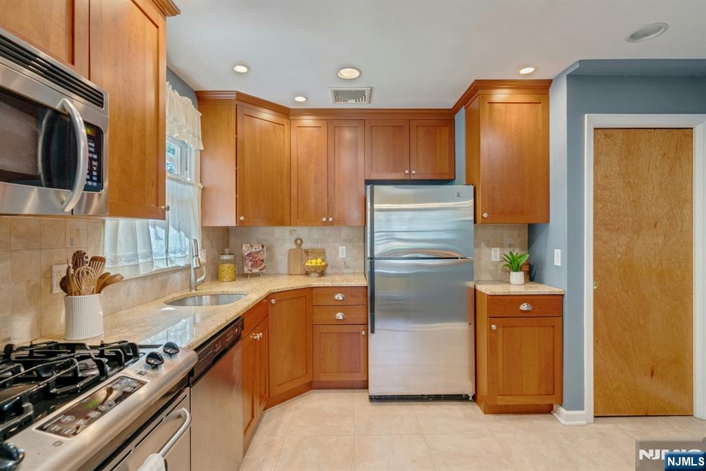 90 Arnot Place Paramus, NJ 07652 - Photo 8 of 32 a kitchen with a refrigerator and a sink