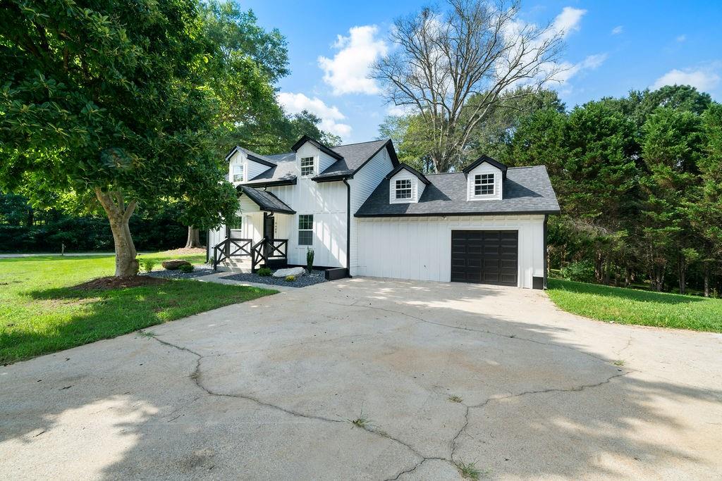 6488 Nebo Road Hiram, GA 30141 - Photo 1 of 32 a front view of a house with garden