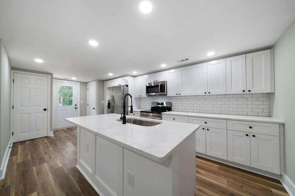 6488 Nebo Road Hiram, GA 30141 - Photo 12 of 32 a kitchen with a sink a stove and cabinets