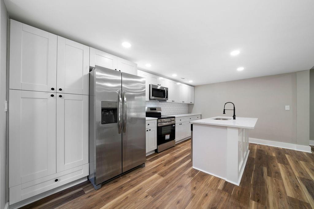 6488 Nebo Road Hiram, GA 30141 - Photo 15 of 32 a kitchen with a refrigerator sink and cabinets