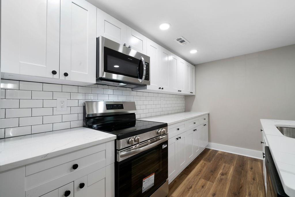 6488 Nebo Road Hiram, GA 30141 - Photo 16 of 32 a kitchen with granite countertop white cabinets stainless steel appliances and sink