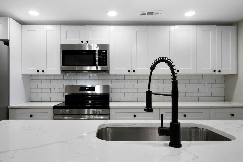 6488 Nebo Road Hiram, GA 30141 - Photo 17 of 32 a kitchen with stainless steel appliances granite countertop a sink a stove a microwave and a refrigerator