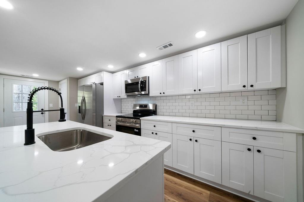 6488 Nebo Road Hiram, GA 30141 - Photo 18 of 32 a kitchen with stainless steel appliances granite countertop a sink a stove and cabinets