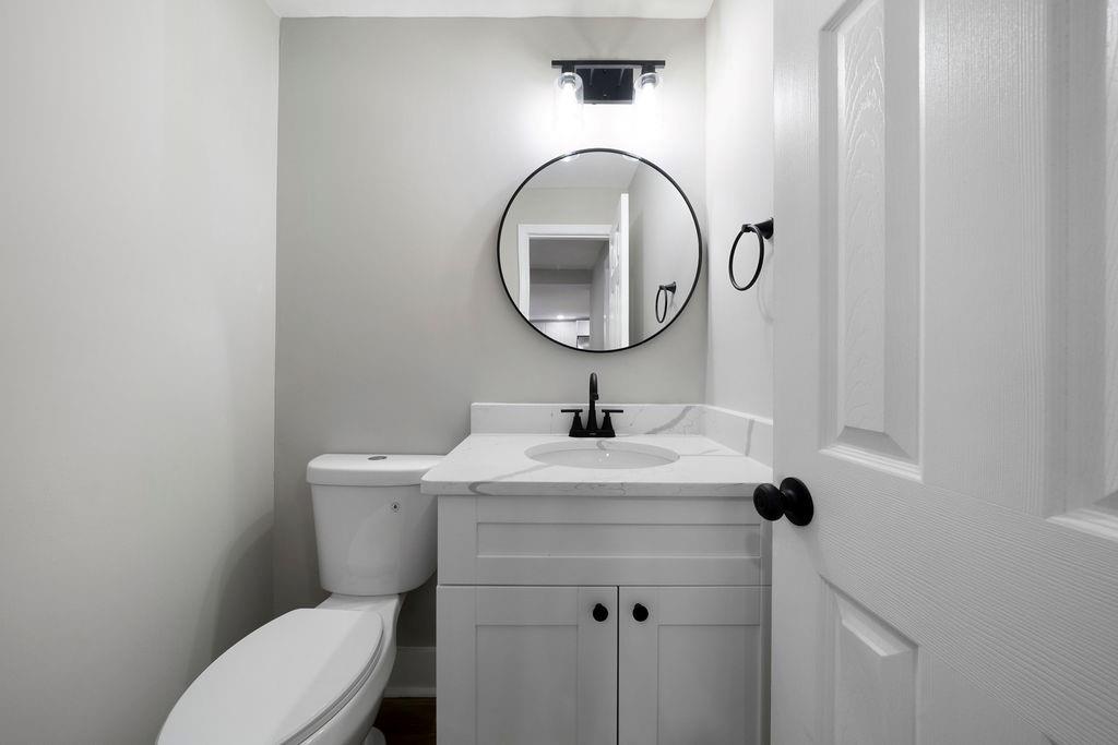 6488 Nebo Road Hiram, GA 30141 - Photo 19 of 32 a bathroom with a toilet sink and mirror
