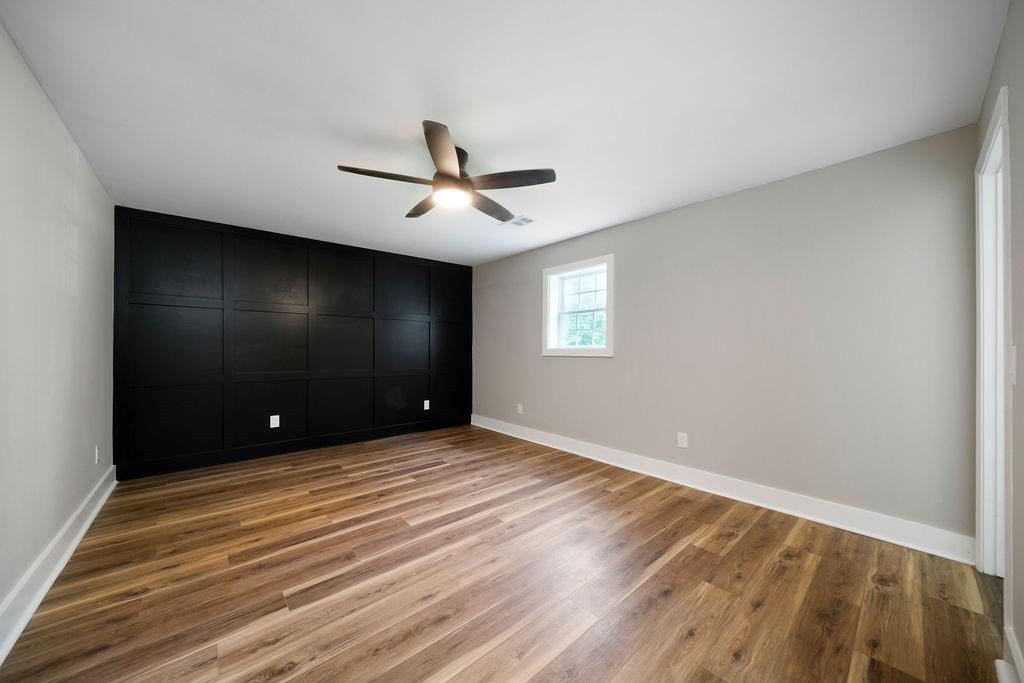 6488 Nebo Road Hiram, GA 30141 - Photo 22 of 32 a view of empty room with wooden floor and fan