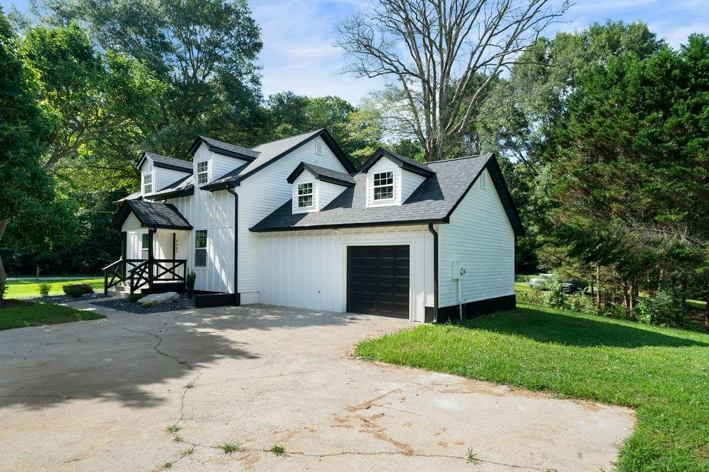 6488 Nebo Road Hiram, GA 30141 - Photo 4 of 32 a front view of a house with a yard and garage