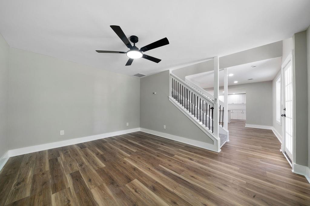 6488 Nebo Road Hiram, GA 30141 - Photo 7 of 32 a view of an empty room with wooden floor and a ceiling fan