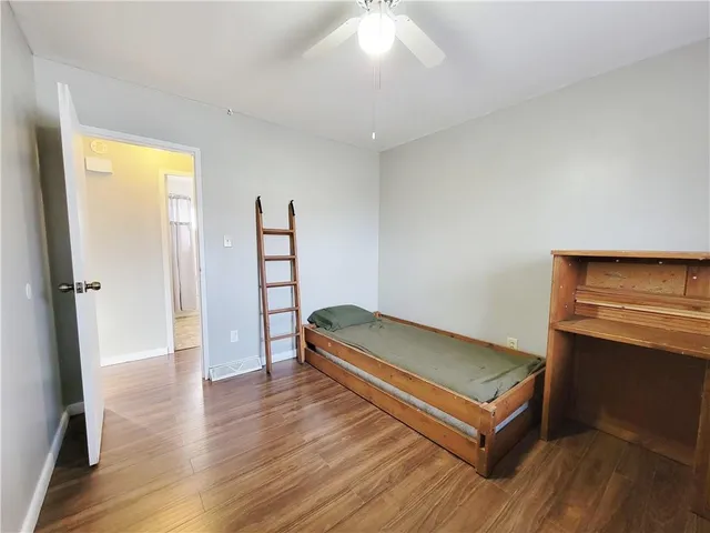 a view of a room with wooden floor and window