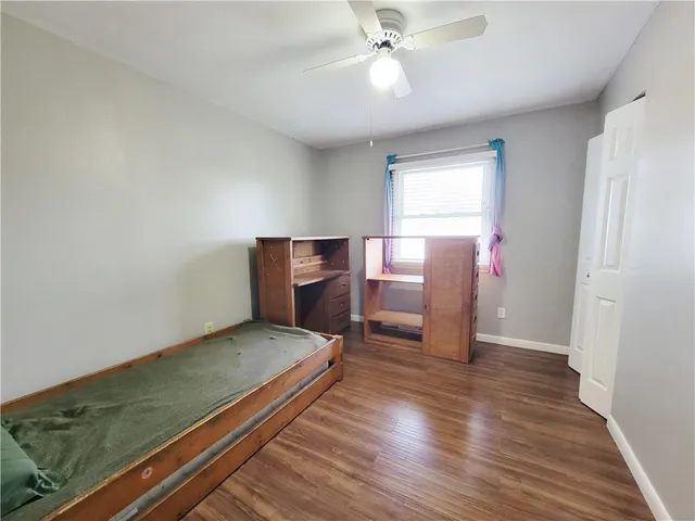 a view of a room with wooden floor and staircase