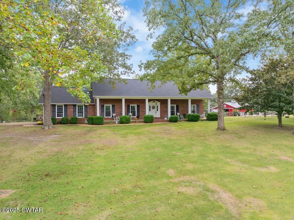 255 Hartley Road Camden, TN 38320 - Photo 3 of 79 a front view of house with outdoor seating and yard